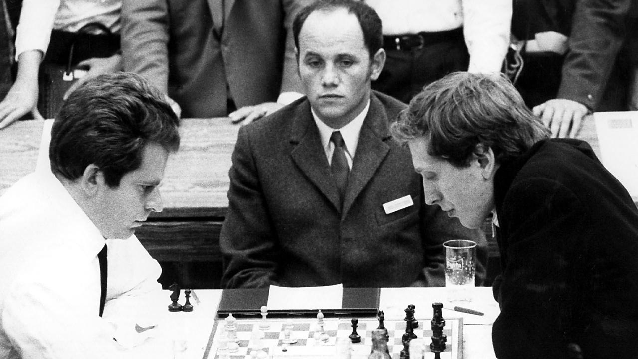Black and white photo of Boris Spassky and Bobby Fischer staring intently at a chessboard