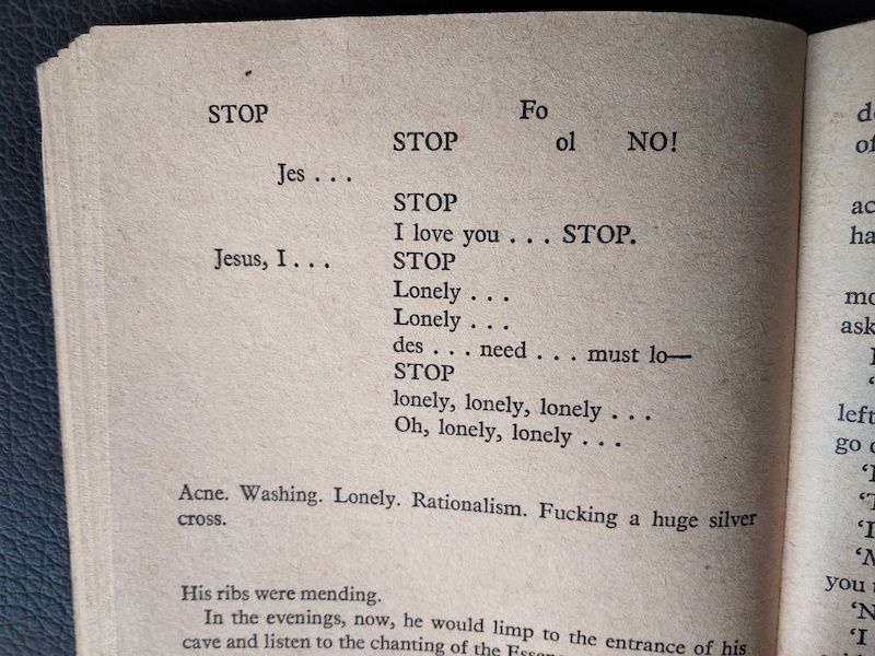 Photo of a book page with the words 'Jesus' 'STOP' 'Lonely' and 'I love you' scattered randomly around the page from left to right.