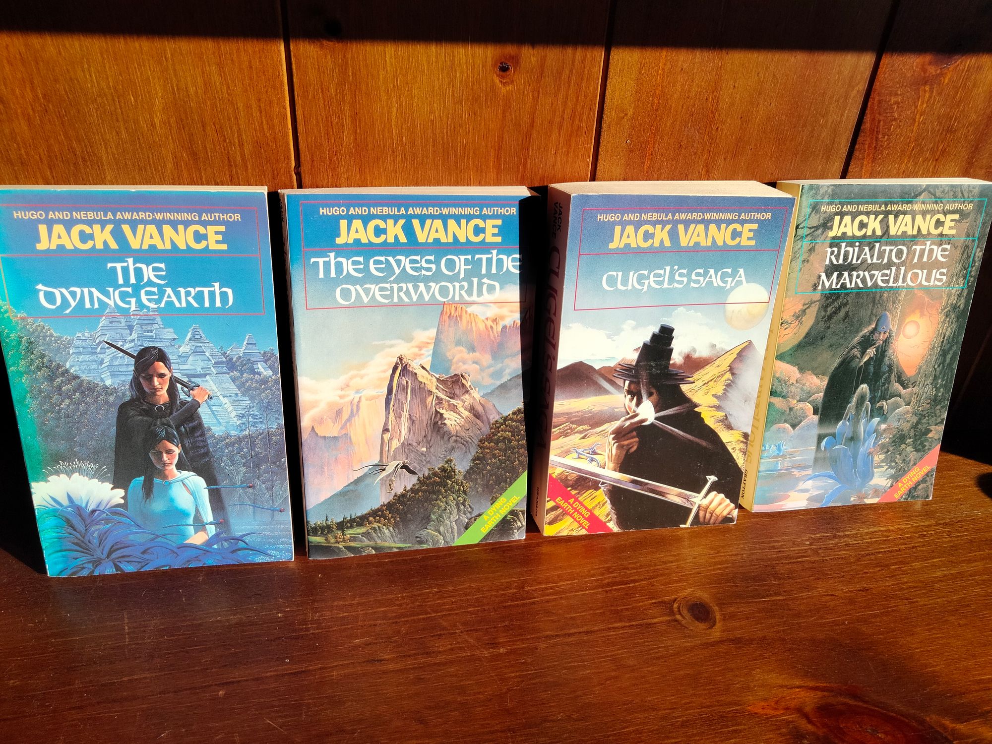Covers of The Dying Earth, The Eyes of the Overworld, Cugel's Saga and Rhialto the Marvellous, all by Jack Vance. The covers depict various wizards, heroes and fantasy landscapes. The artwork is a bit bland if I'm being honest.