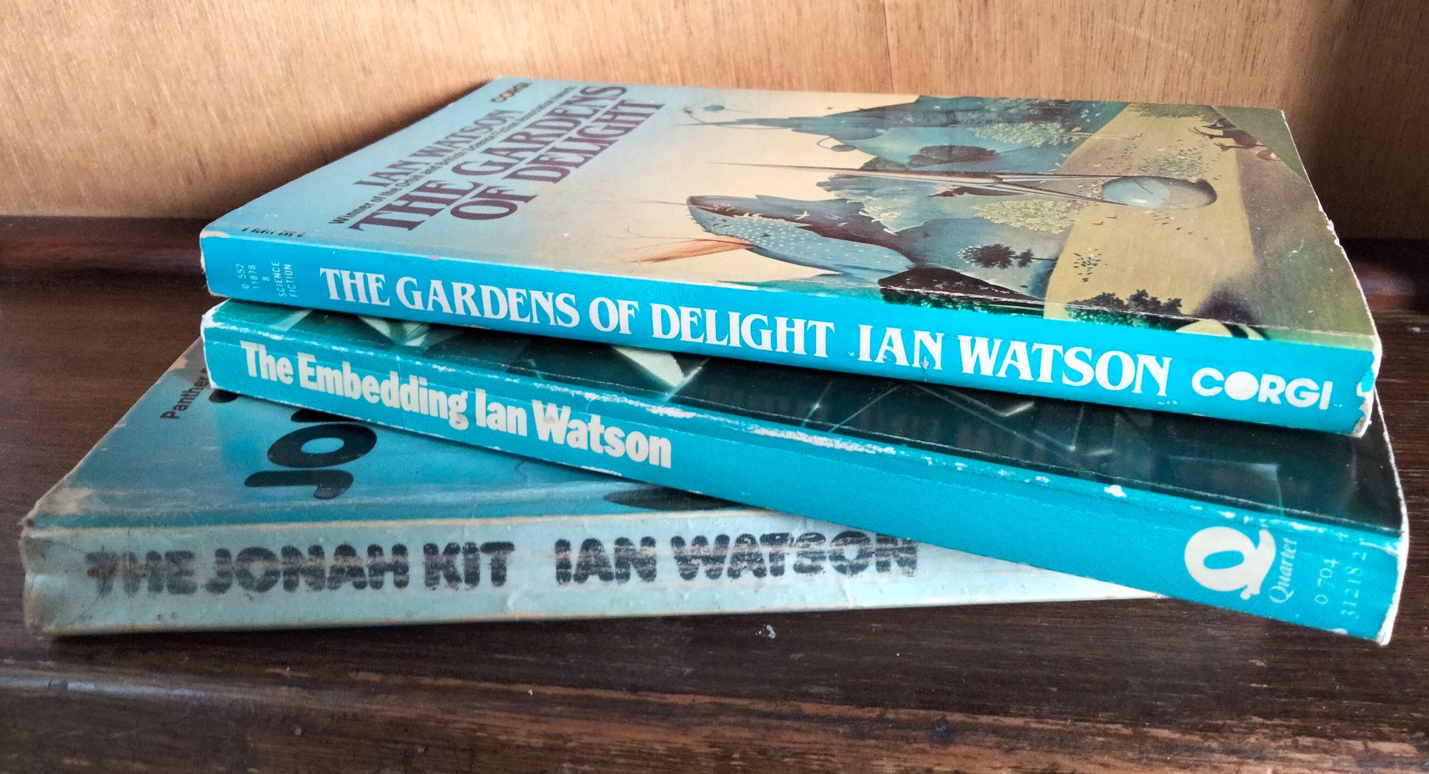 Photo of three old paperback novels stacked loosely together: "The Gardens of Delight", "The Embedding" and "The Jonah Kit", all by Ian Watson.