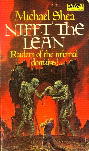 Book cover depicting a man on his knees before two enormous mummies in a hellish landscape. One mummy holds a giant pitchfork with a cloaked body impaled upon it. The novel's tagline reads: "Raiders of the infernal domains!"