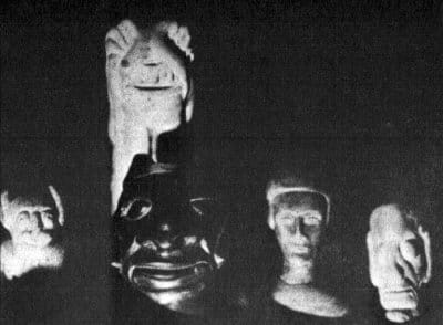 Another spooky, grainy photo of Smith's sculptures. There are five in this picture, all little goblin guys, looking at the camera as though they're about to do something nasty to you.