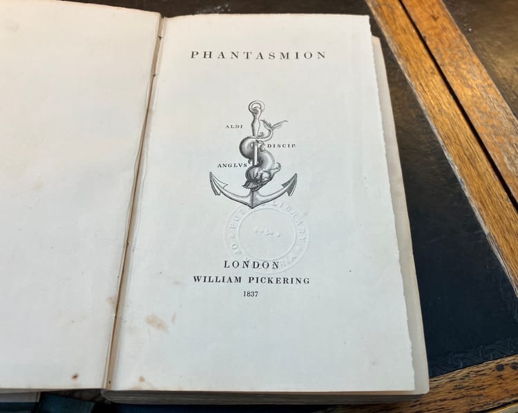 Title page of a very old book with a stamped image of a fish coiling around an anchor.
