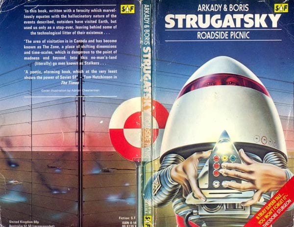 Cover of "Roadside Picnic". A guy in a weird egg-shaped spacesuit holds a strange mechanical device.